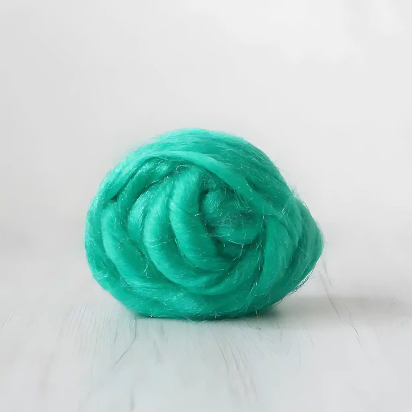 Coil of emerald green Firestar nylon top sparkle fiber by Paradise Fibers