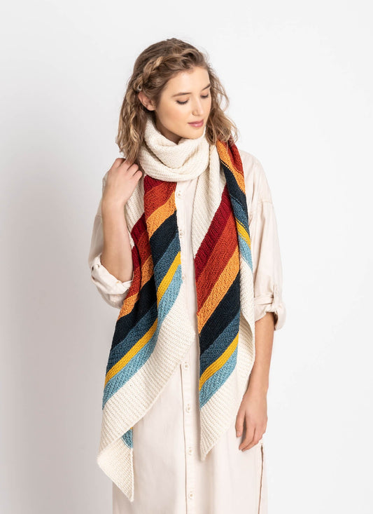 Gresham Wrap looped at the neck, showing diagonal textured stripes in red, rust, orange, navy, blue, gold and pale blue