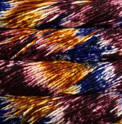 Color: Pintada Xilofono 169. A maroon, orange, blue and white variant of Malabrigo Rasta yarn. 