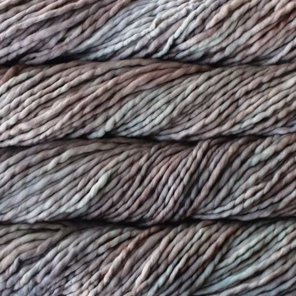 Color: Whole Grain 696. A taupe and light pink variegated variant of Malabrigo Rasta yarn. 