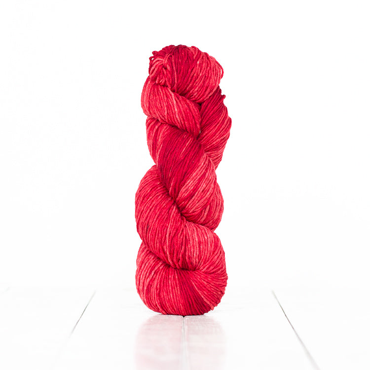 Color 6051, a variegated monochromatic skein of bright red yarn.