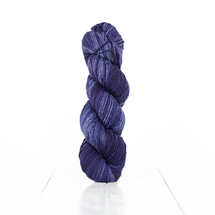 Color 6056, a variegated monochromatic skein of dark blue yarn.