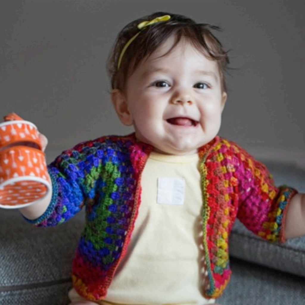 The front of a hand crocheted Squared Up Baby Jacket.