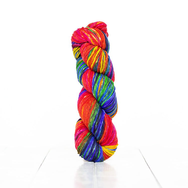 Color 6004, hand-dyed self-striping yarn in vibrant primary rainbow colors.