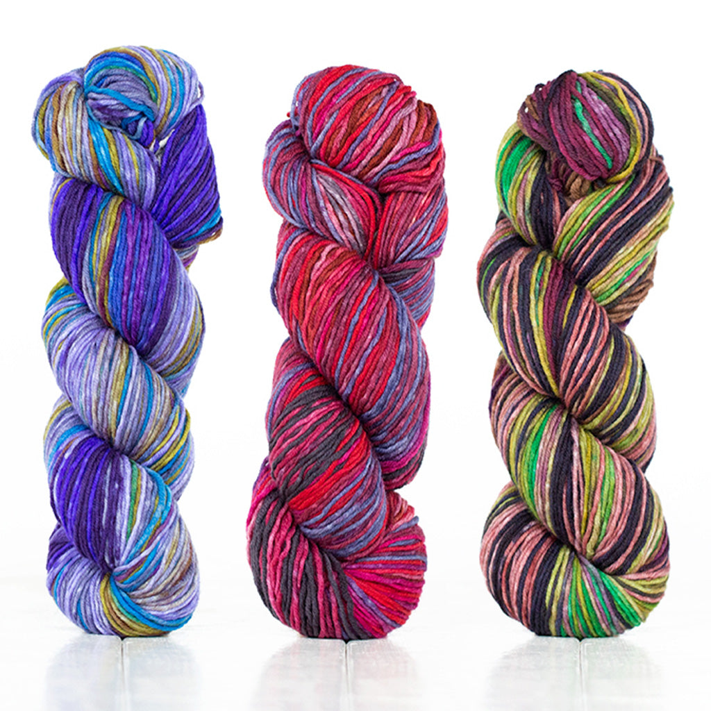 3 skeins of Uneek DK showcasing the vibrant depth of color these hand-dyed yarns have.