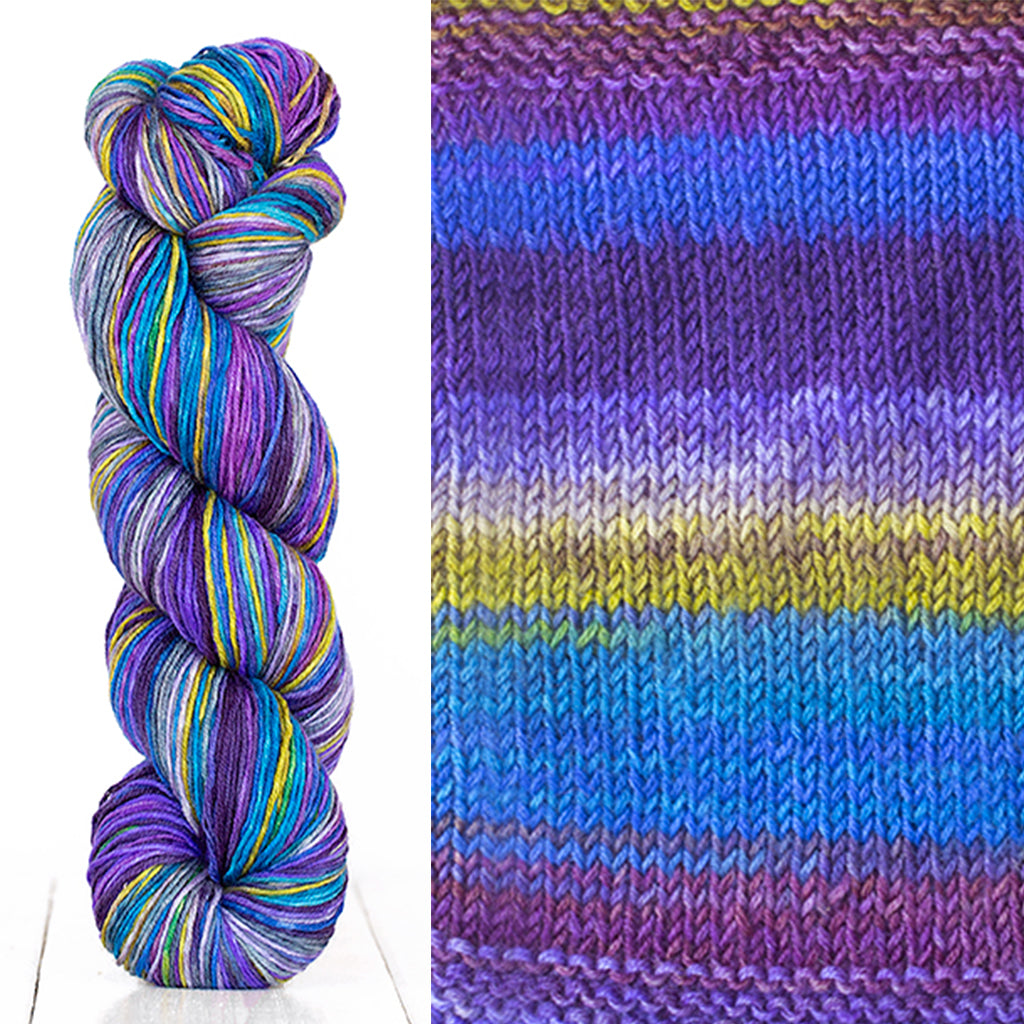 Color 3003: a hand-dyed skein of self striping wool yarn with blue, purple, white, and yellow shades
