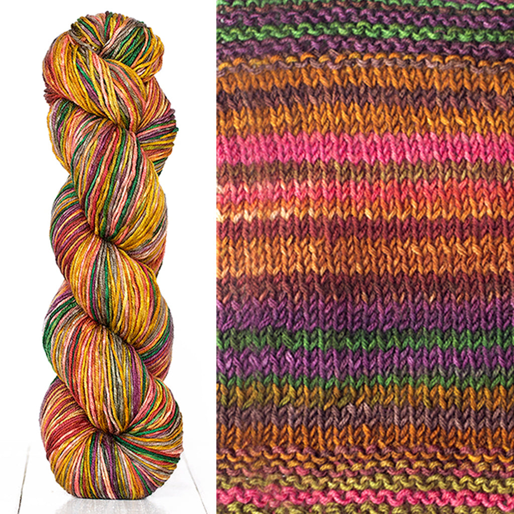 Color 3008: a hand-dyed skein of self striping wool yarn with brown, pink, orange, and purple shades