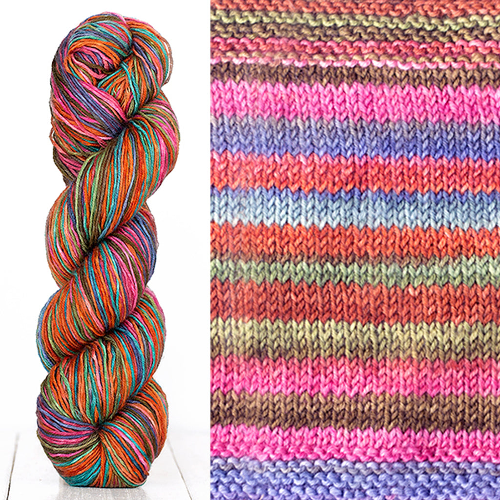 Color 3011: a hand-dyed skein of self striping wool yarn with pink, purple, red, and brown shades