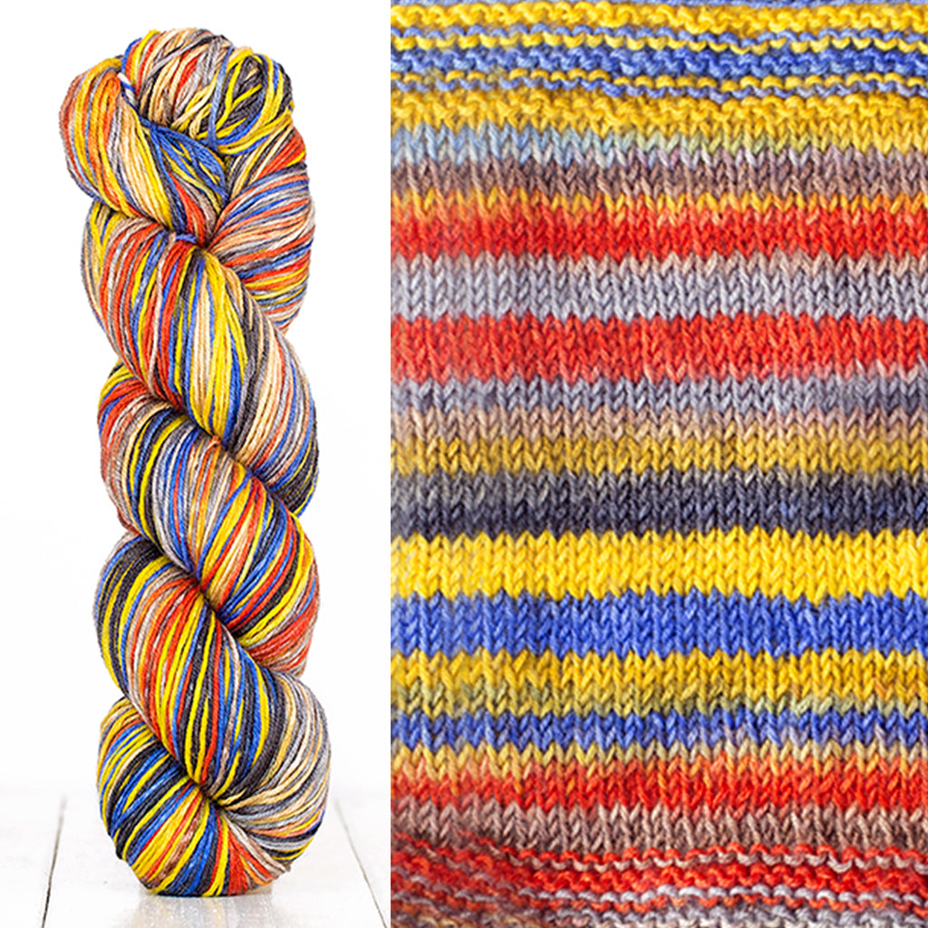 Color 3015: a hand-dyed skein of self striping wool yarn with yellow, red, blue, and grey shades