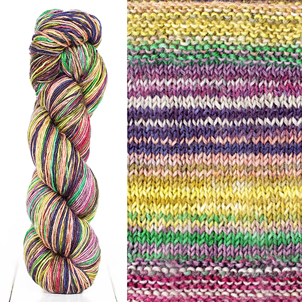 Color 3018: a hand-dyed skein of self striping wool yarn with purple, yellow, green, and pink shades