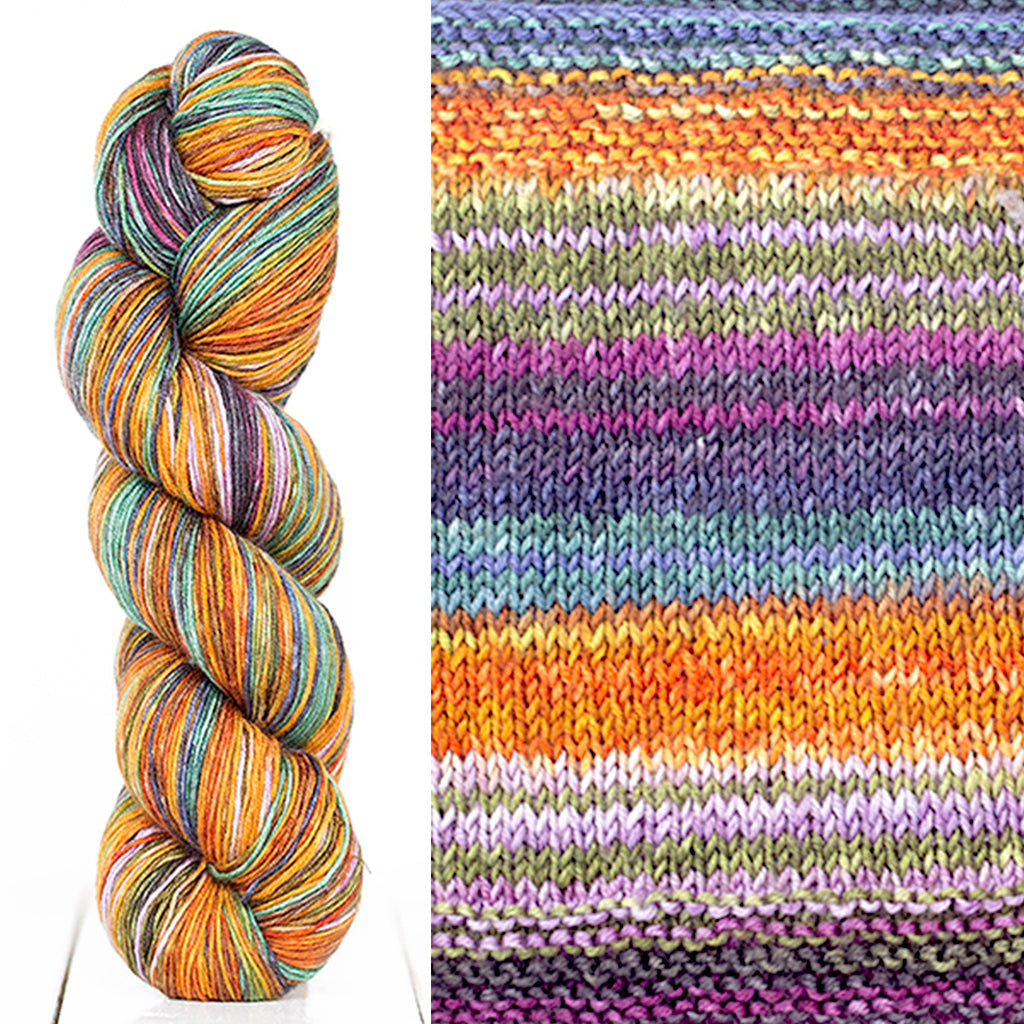 Color 3020: a hand-dyed skein of self striping wool yarn with purple, orange, blue, and tan shades