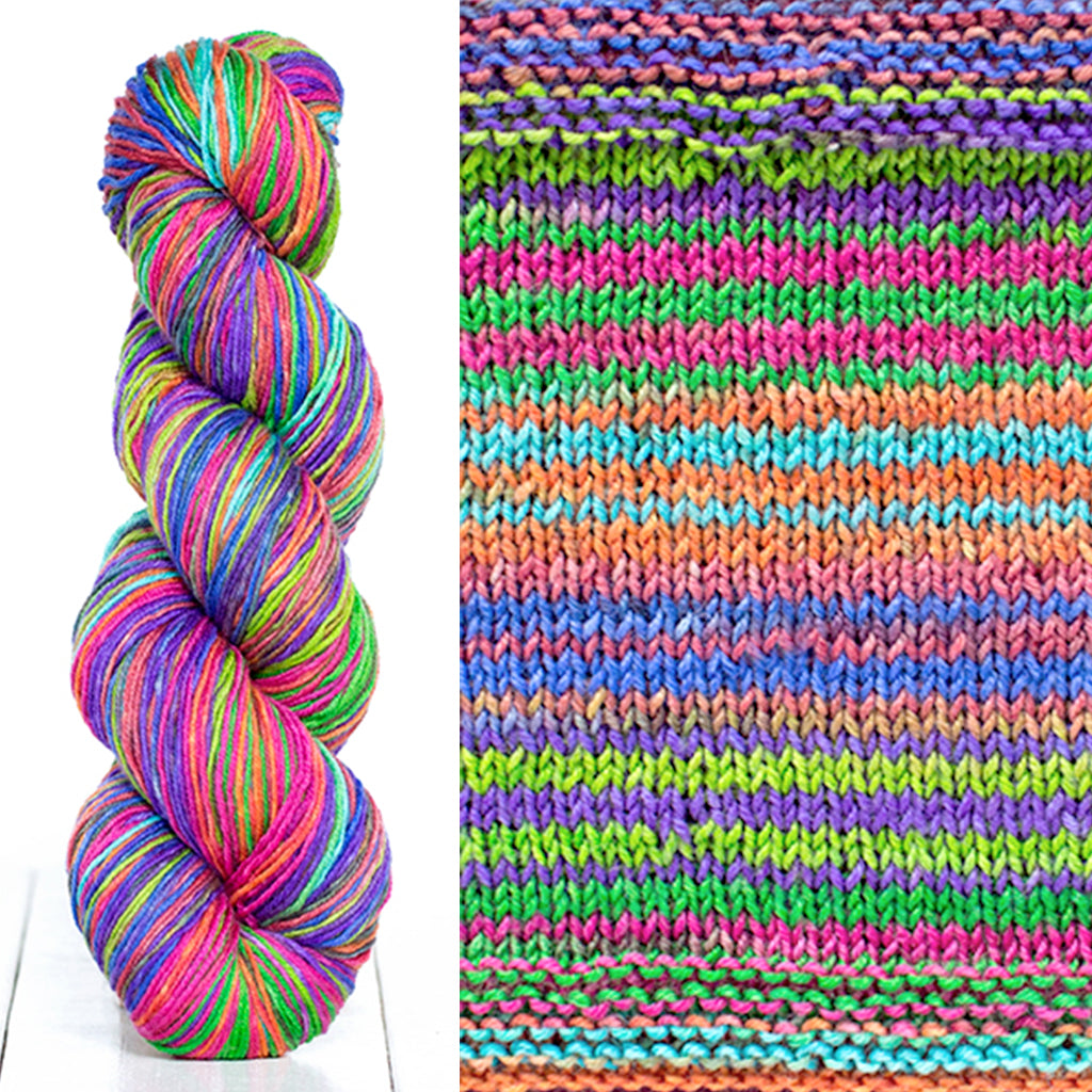 Color 3023: a hand-dyed skein of self striping wool yarn with blue, green, pink, and purple shades