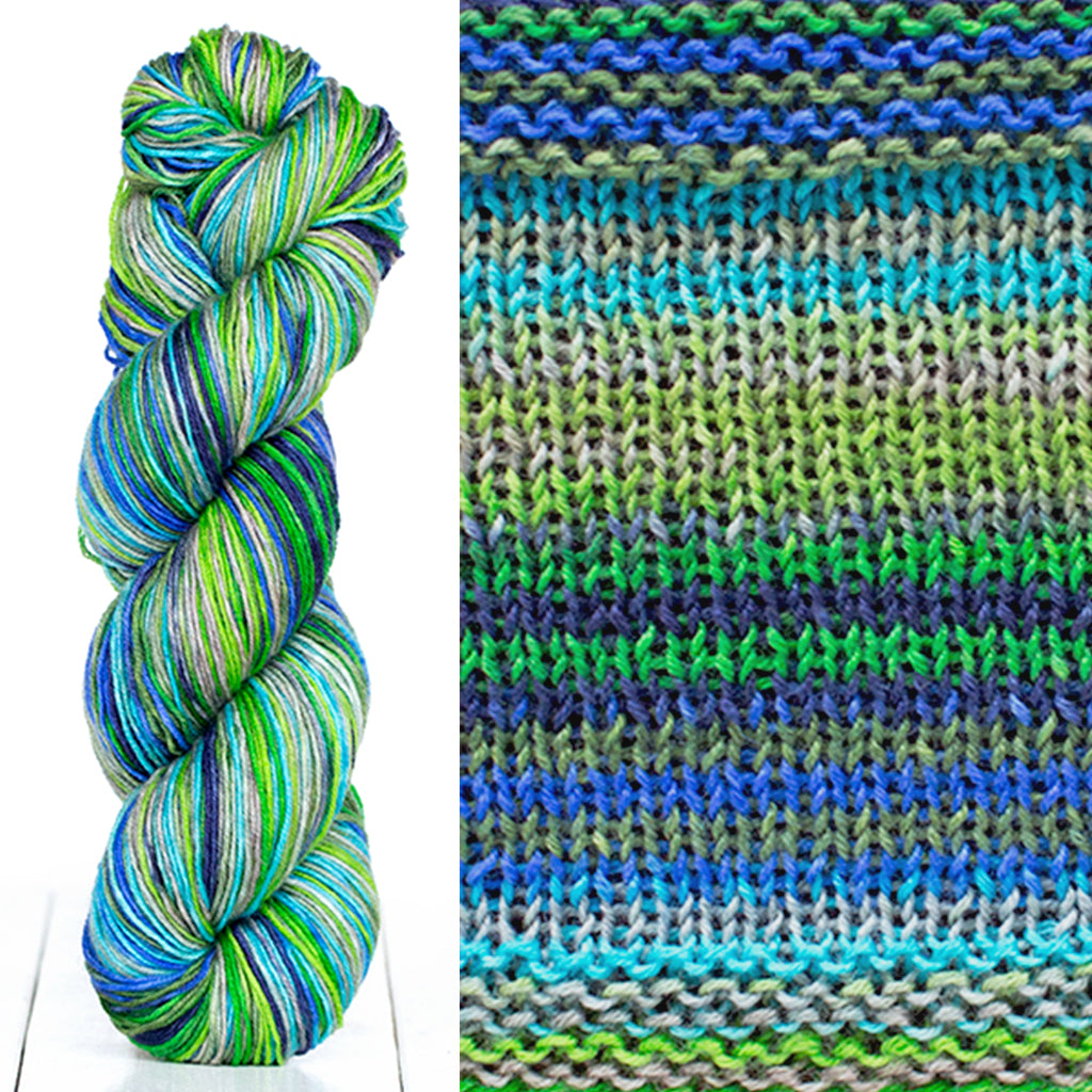 Color 3025: a hand-dyed skein of self striping wool yarn with blue, green, and grey shades