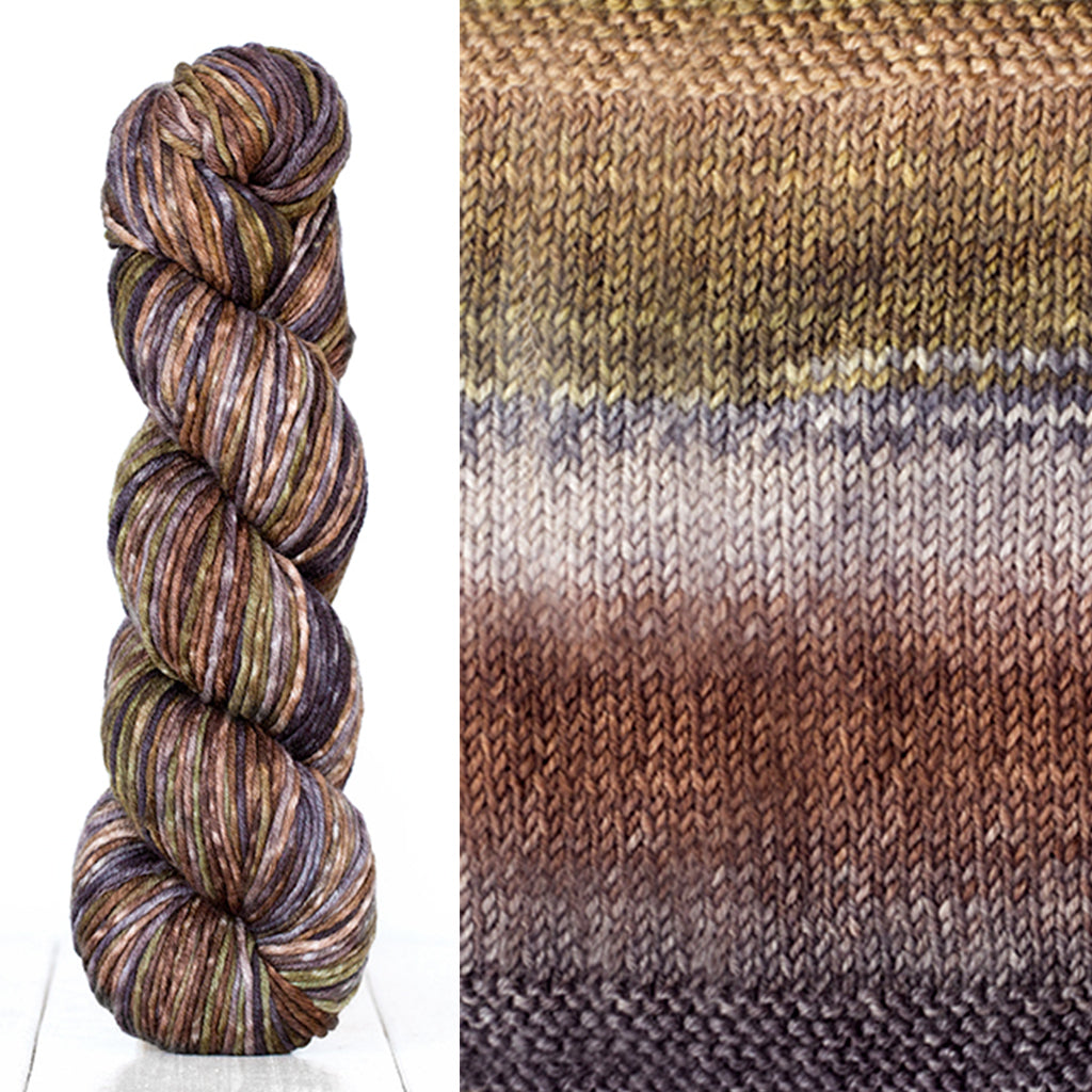 Color 4006: a hand-dyed skein of self striping wool yarn with brown, white, grey, and tan shades