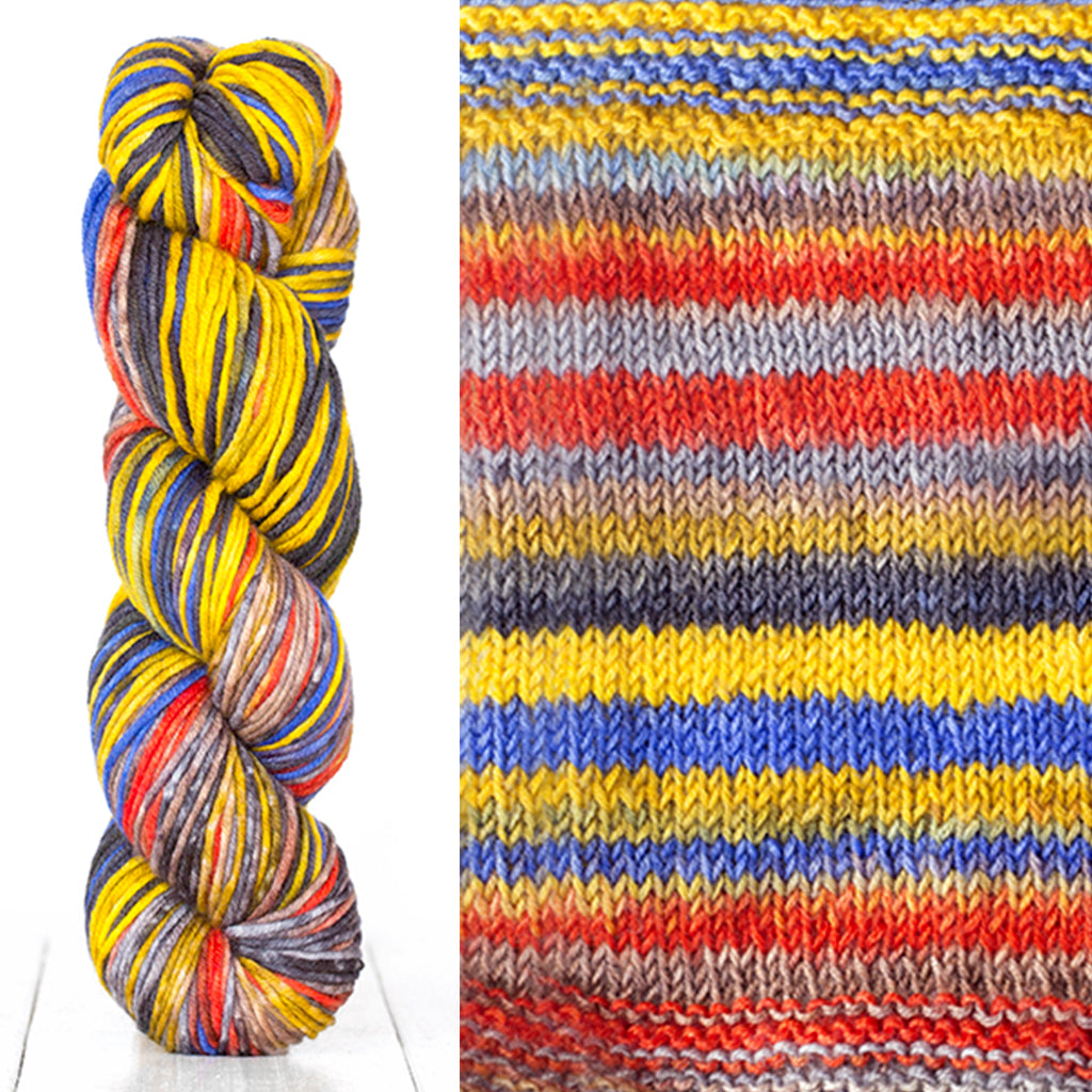 Color 4015: a hand-dyed skein of self striping wool yarn with yellow, red, blue, and grey shades