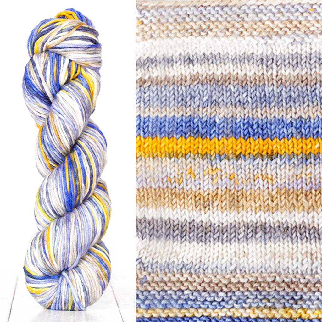 Color 4016: a hand-dyed skein of self striping wool yarn with white, grey, yellow, and blue shades
