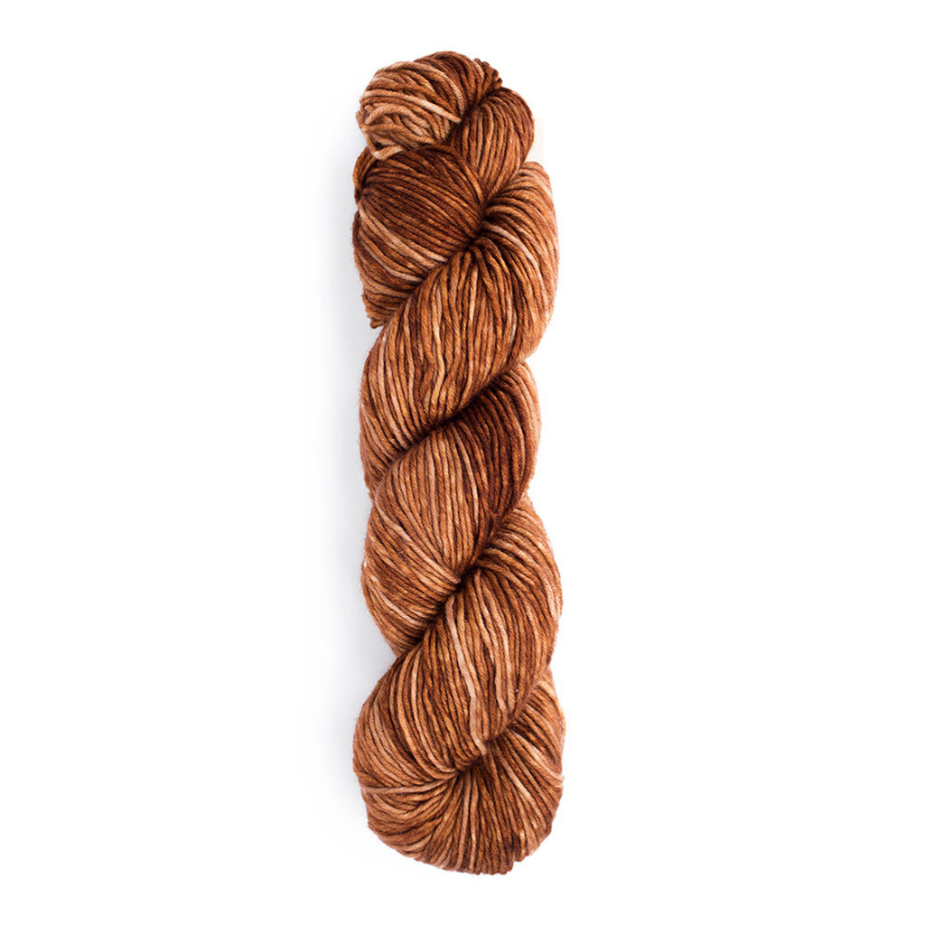A skein of Monokrom Worsted, color 4060, a warn, tonal, brown.