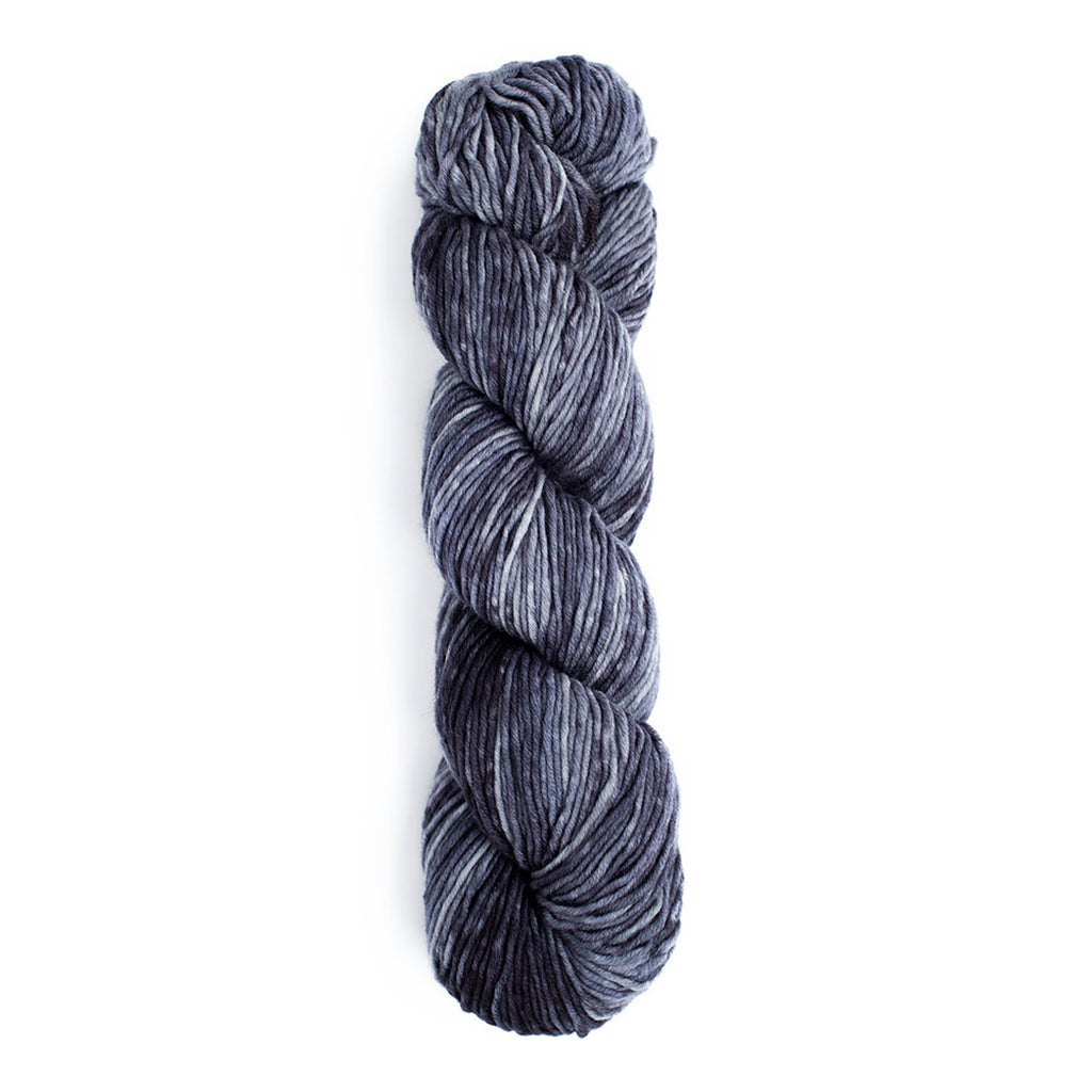 A skein of Monokrom Worsted, color 4063, a cool toned, dark, smokey grey.