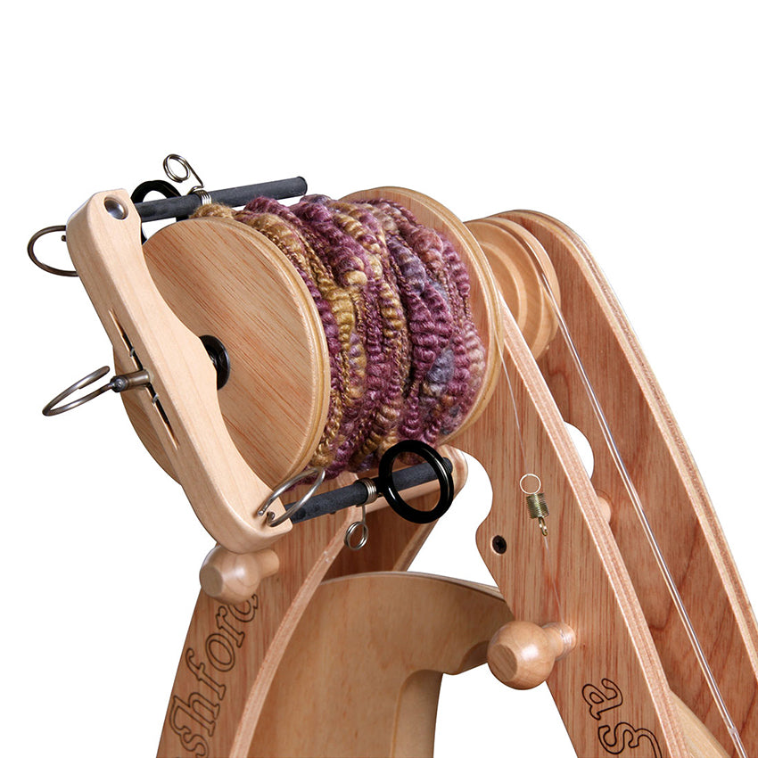 Ashford Joy sliding hook freedom flyer on the wheel with art yarn.