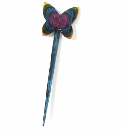 Multi colored wooden stick pin with a butterfly on top.