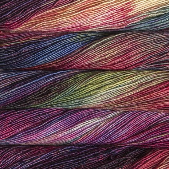Malabrigo Mechita Aniversario yarn - a variegated colorway in reds blues, pinks and greens
