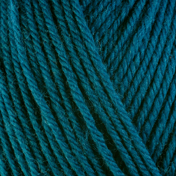 Kale 3341, a dark turquoise blue skein of washable worsted weight Ultra Wool yarn.