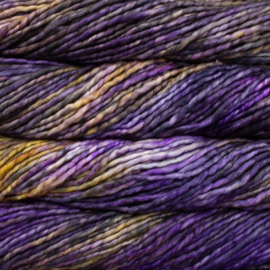 Color: Amatista 189. A purple and gold variegated variant of Malabrigo Rasta yarn. 
