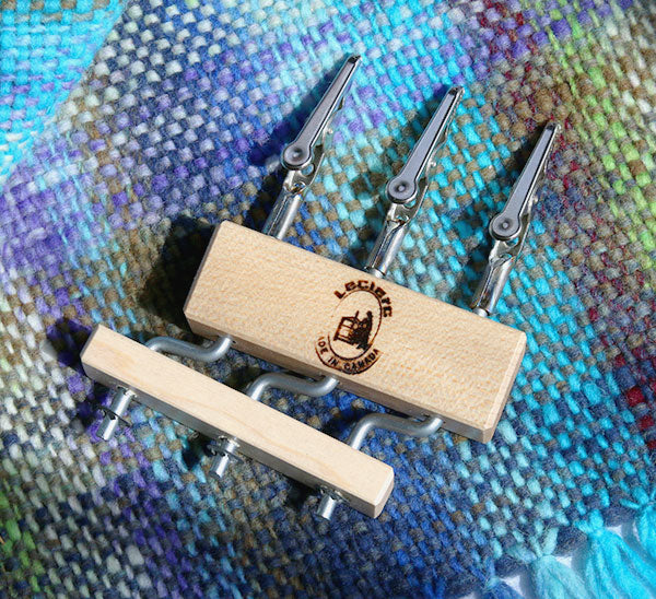 Wooden lacis triple holder on colorful woven fabric