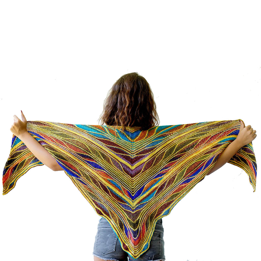 Model wearing the Butterfly Papillon Shawl Pattern in the shades gold, red, and blue.