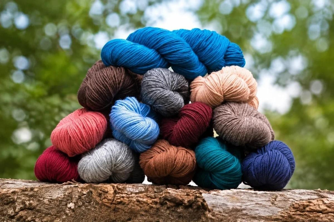colorful skeins of natural yarn for a blanket stacked on a log