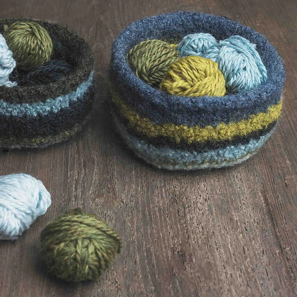 various balls of yarn inside yarn baskets to show what worsted weight yarn is