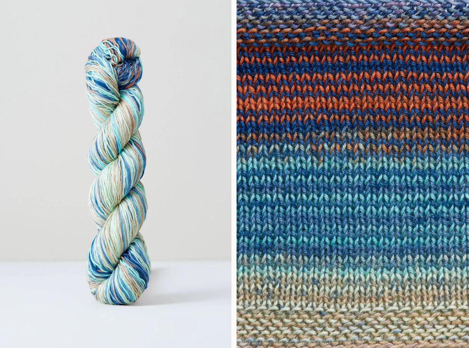 Color 1073: a hand-dyed skein of self striping cotton yarn with blue, green, orange, and grey shades