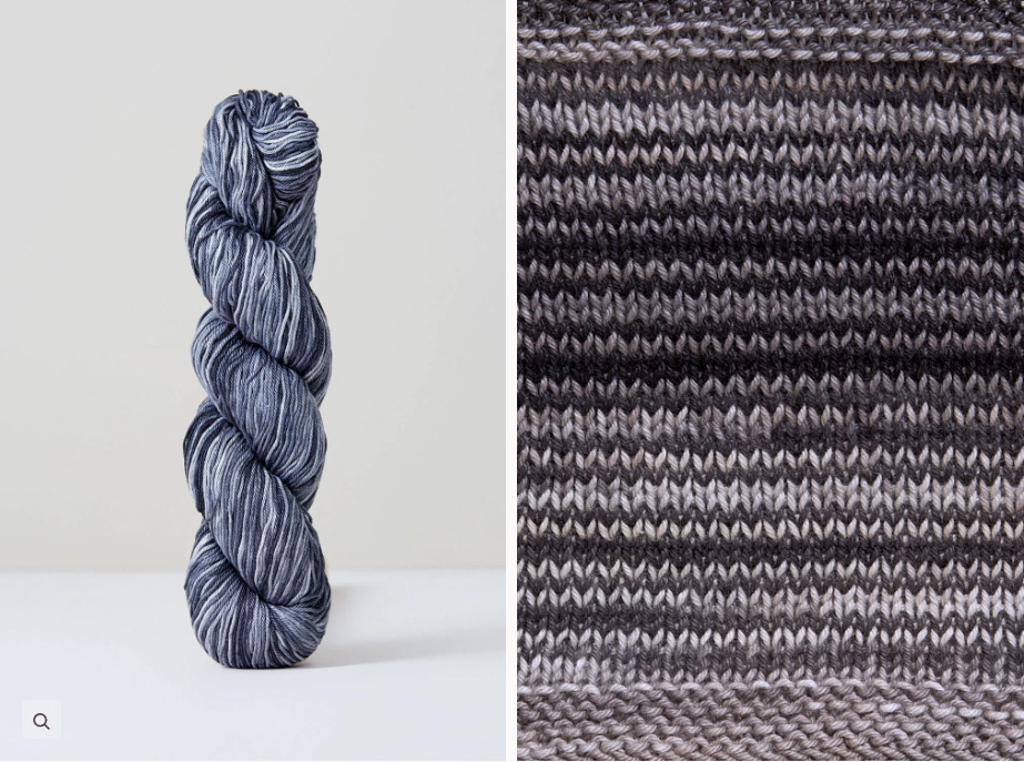 Color 1076: a hand-dyed skein of self striping cotton yarn with black, grey, and white shades
