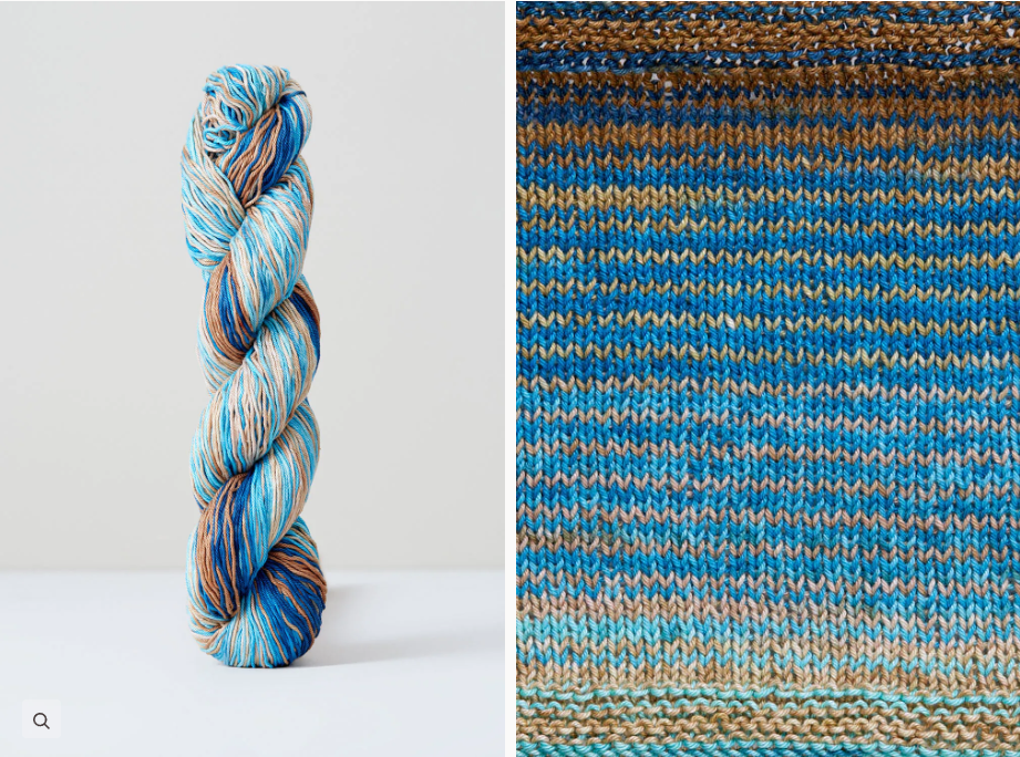 Color 1087: a hand-dyed skein of self striping cotton yarn in shades of blues, gold and greys.