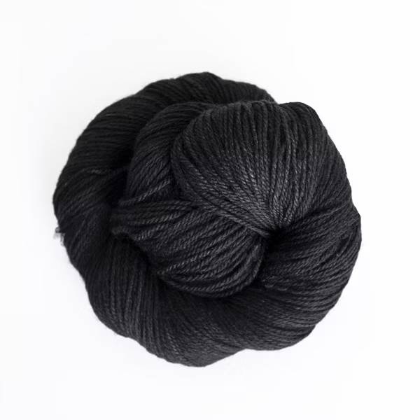Black yarn ball on white background.
