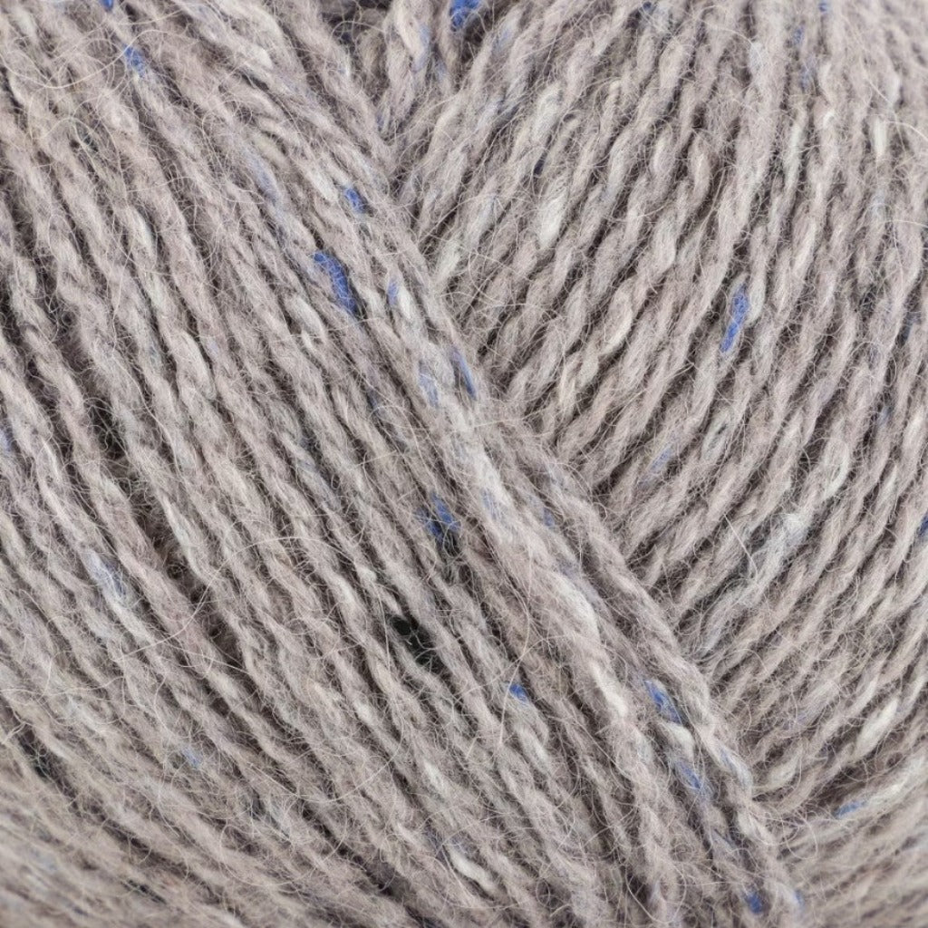 Aluminum 210: A heathered tweed yarn in a light beige color with flecks of blue and white.