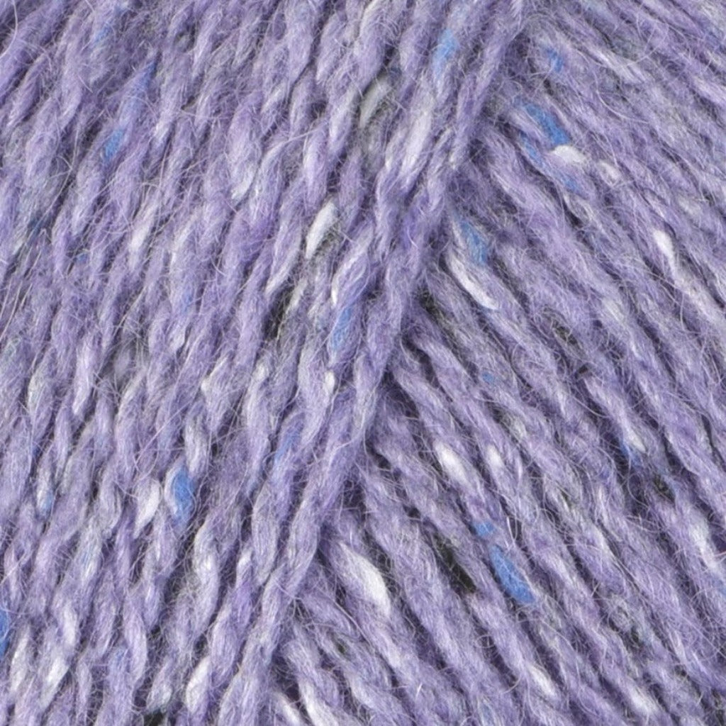 Astor 217: A heathered tweed yarn in a pale dusty purple color with flecks of blue and white.
