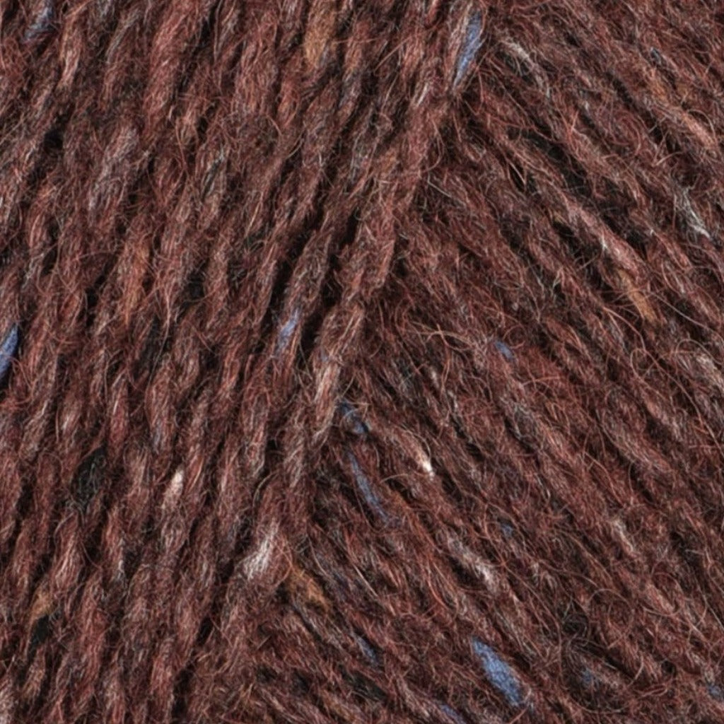Barn Red 196: A heathered tweed yarn in a deep rusty brown color with flecks of blue and white.
