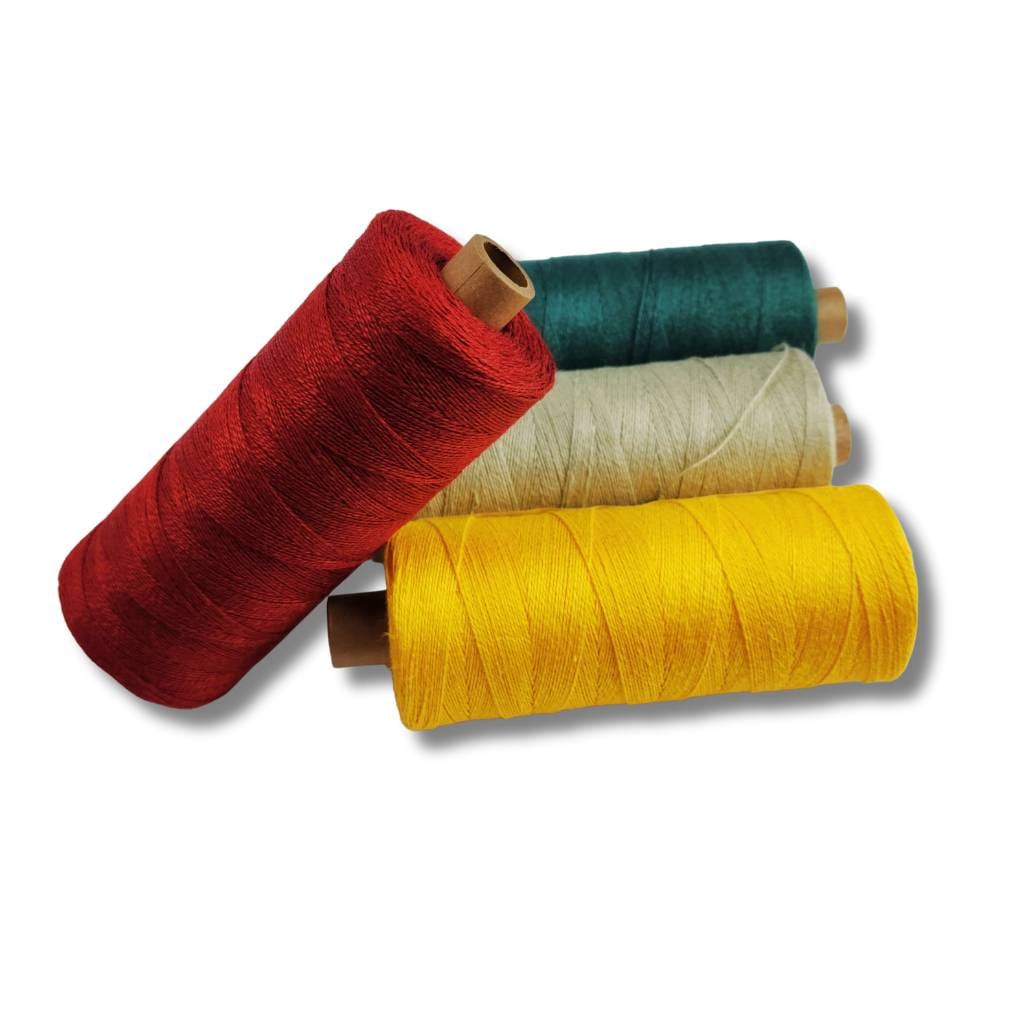 Bockens linen thread spools in red, green, cream, and yellow.