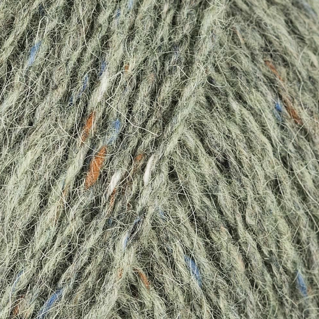 Celadon 184: A heathered tweed yarn in a dusty green color with flecks of orange and blue.
