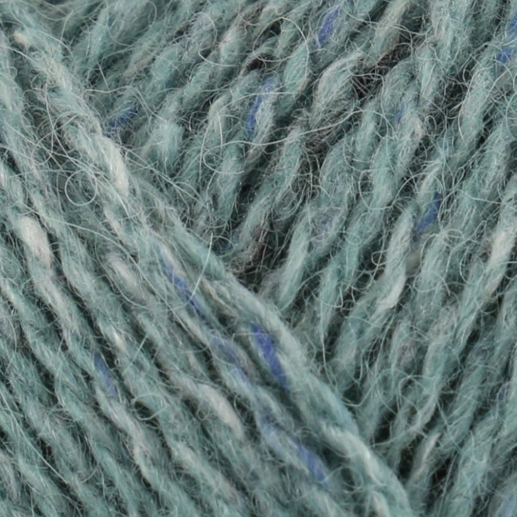 Eden 209: A heathered tweed yarn in a dusty blue green color with flecks of blue and white.