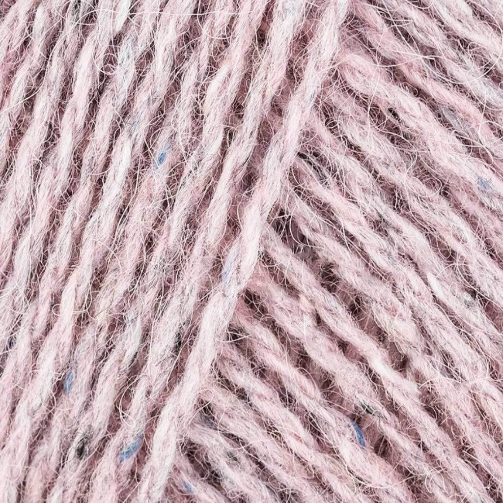 Frozen 185: A heathered tweed yarn in a pale pink color with flecks of blue, black and white.
