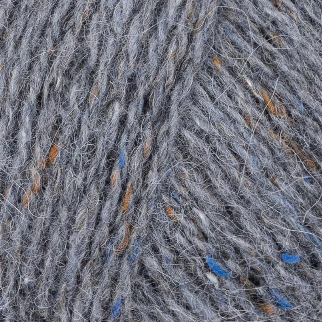 Granite 191: A heathered tweed yarn in a medium grey color with flecks of brown and blue.