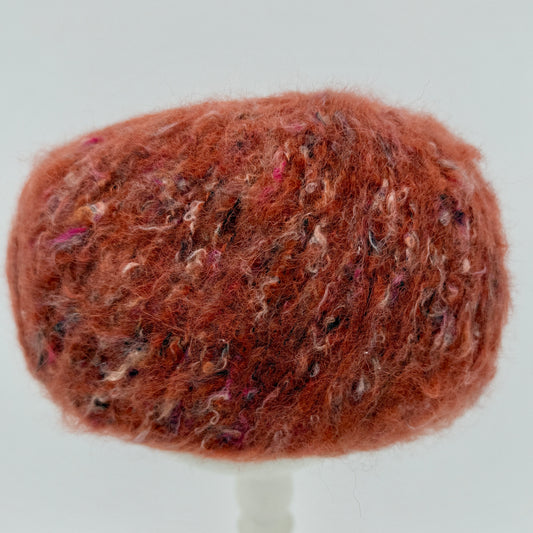 Mirasol Rit'i Aran Yarn color 07 Wool and Roses, rust orange ball with pink flecks
