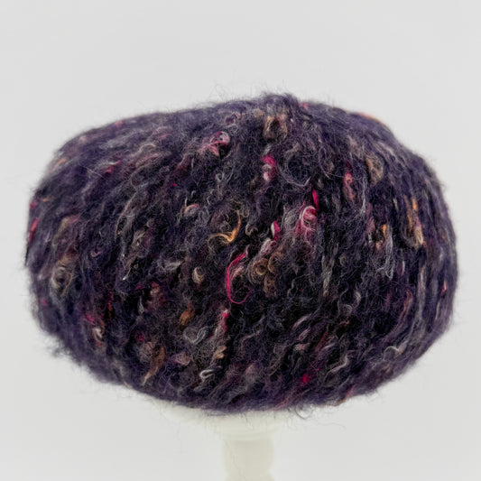 Mirasol Rit'i Aran Yarn color 08 Mulberry Mist, deep purple ball with pink flecks