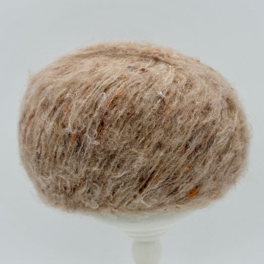 Mirasol Rit'i Aran Yarn color 04 Oat Ember, oatmeal tan ball with orange flecks