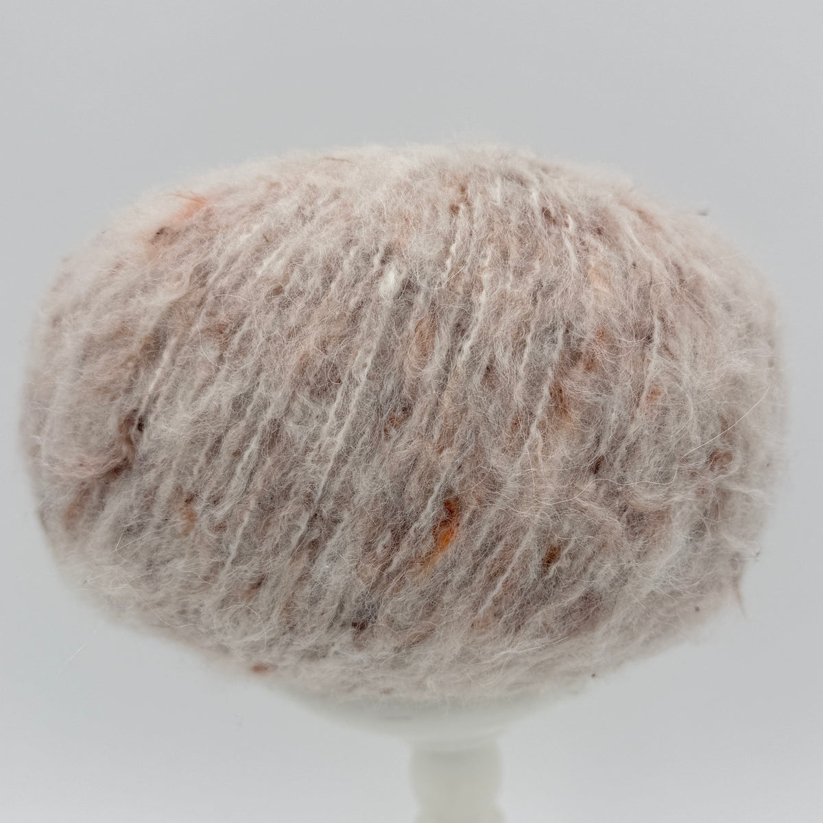 Mirasol Rit'i Aran Yarn color 03 Autumn Snow, blush cream ball with rust flecks