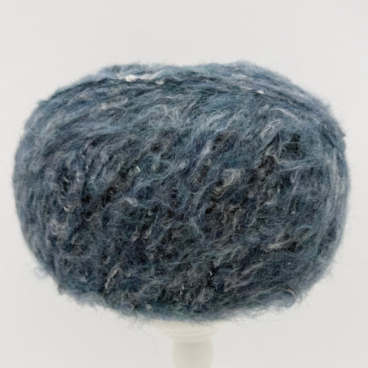 Mirasol Rit'i Aran Yarn color 05 Denim Sky, blue teal ball with a soft halo