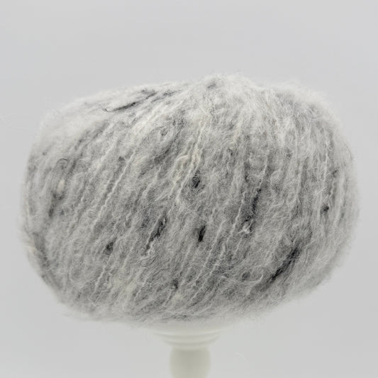 Mirasol Rit'i Aran Yarn color 02 Fleece Fog, pale grey ball with dark flecks