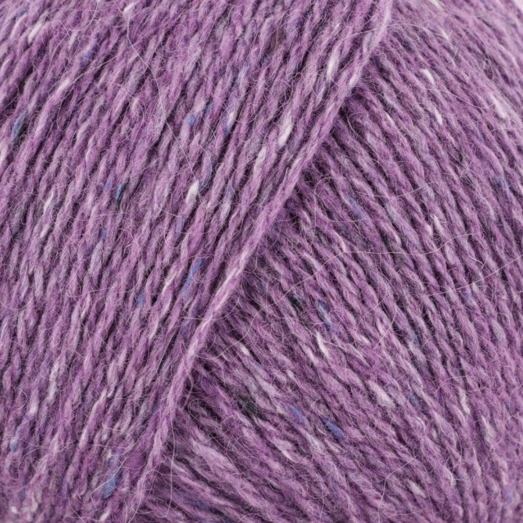 Iolite 208: A heathered tweed yarn in a  dusty lilac purple color with flecks of blue and white.